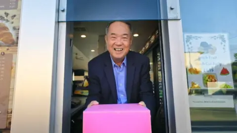 Greenwich Entertainment Ted with the iconic pink doughnut box he popularised