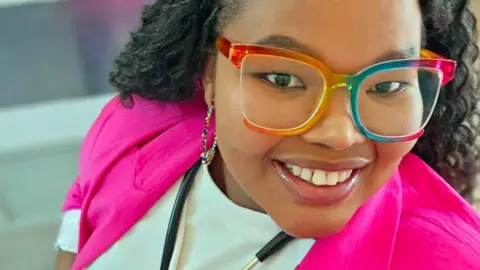 Celiwe Ndaba / Facebook Celiwe Ndaba in a pink top, rainbow-framed glasses and a stethoscope around her neck, smiles for a selfie
