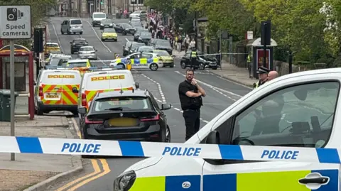 YappApp Police cordons, officers and emergency vehicles at the scene of the incident on Otley Road in Headingley on Saturday