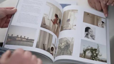 Kevin Church/BBC A photograph of a magazine showing wedding photographs, and two people's hands at the top and bottom of the magazine. The spread showed 8 photographs of two women getting ready for their wedding day, as well as bouquets of flowers.